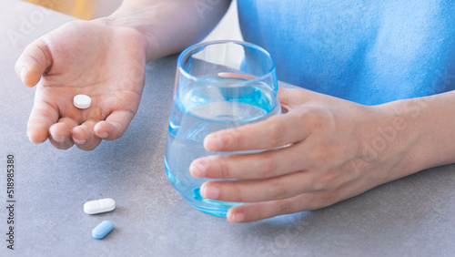 Woman taking her daily prescription pills