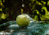 green apple in water drops