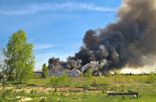 A cloud of smoke of the burning storehouse