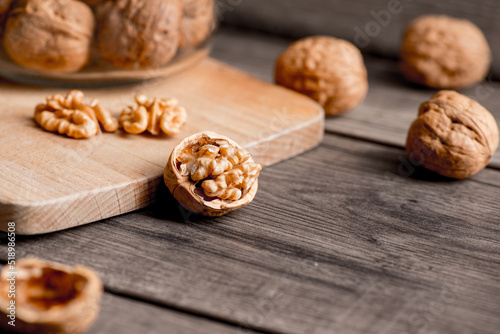 Healthy bio walnuts on wood desk with detail background, walnut on wood kitchen underlay.