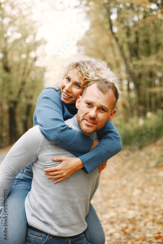 Romantic couple standing in a forest, hugging and posing for a photo © hetmanstock2