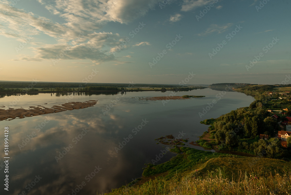 Beautiful river predawn cloudy sky. Early blue sky reflected in water. Colorful morning atmospheric image.