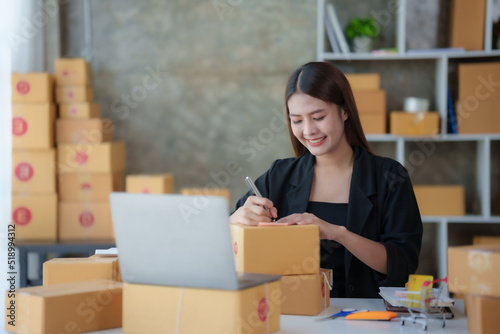 Online business owner Asian woman are using computer to check orders and customer addresses so that they can be delivered to their customers correctly.