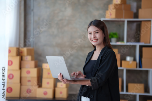 Online business owner Asian woman are using computer to check orders and customer addresses so that they can be delivered to their customers correctly.