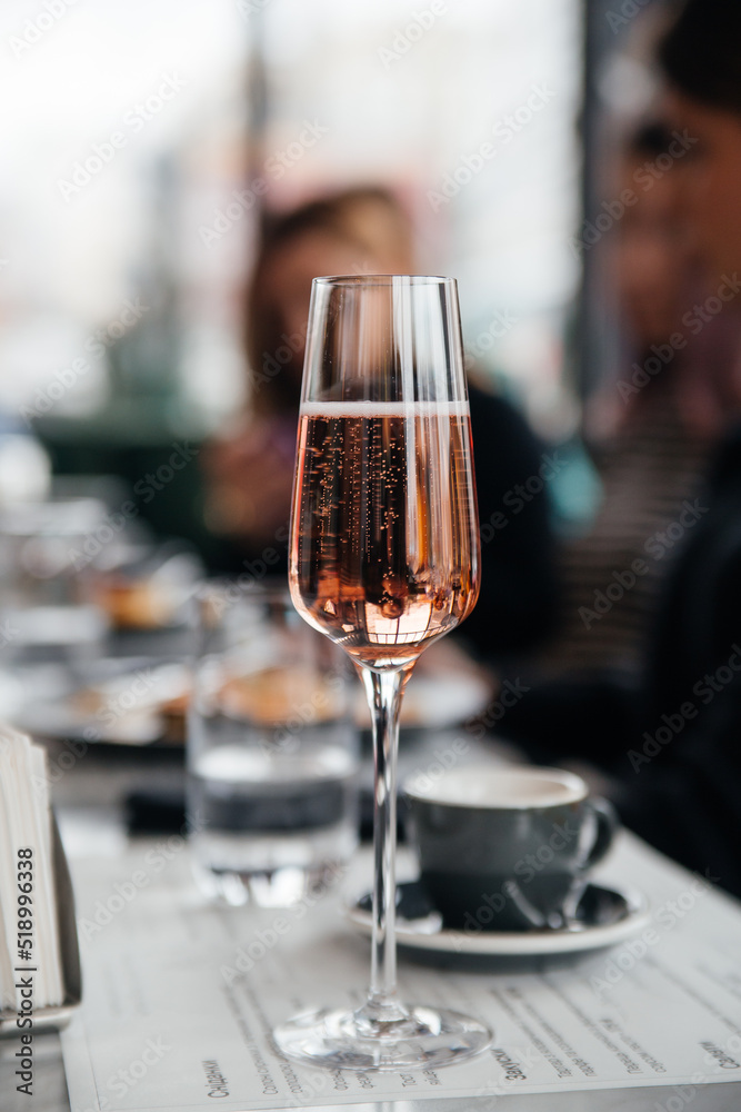 Glass of pink elegant champagne on table in restaurant Glass of pink elegant champagne on table in restaurant