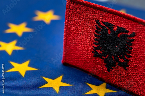 The flag of Albania against the background of the Symbol of the European Union, Concept of Albania's willingness to join the European Community