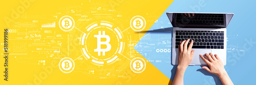 Bitcoin theme with person using a laptop computer