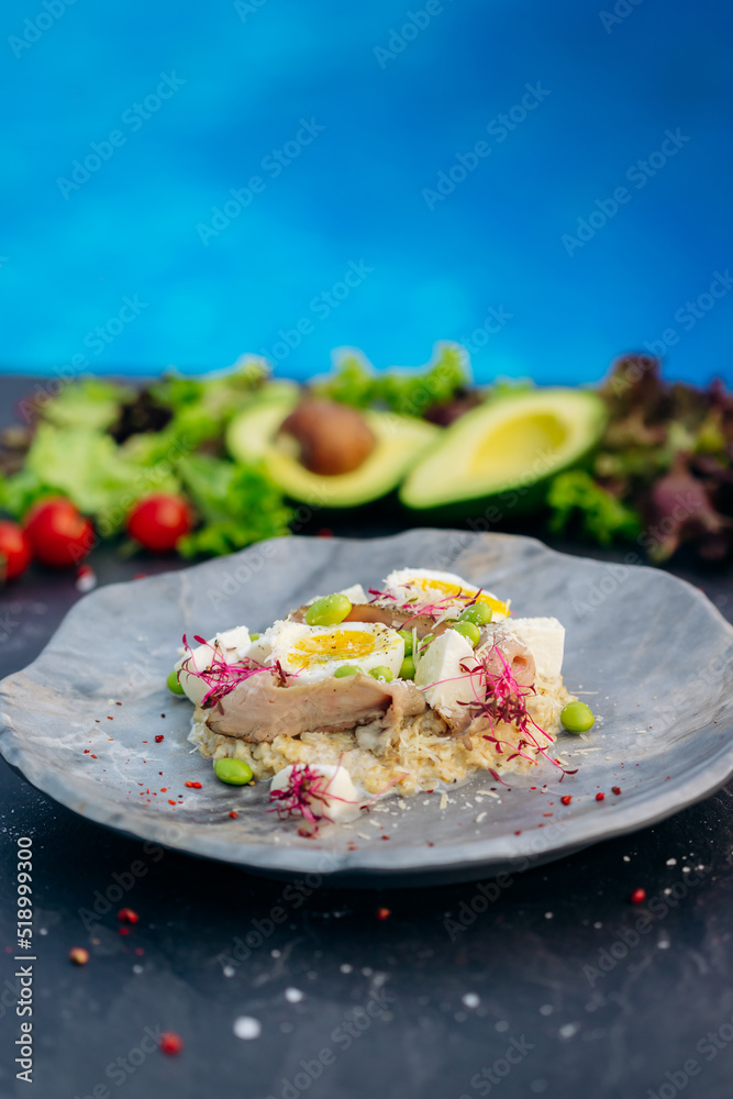 Oatmeal with boiled egg, bacon and green peas. Healthy and tasty breakfast Oatmeal with boiled egg, bacon and green peas. Healthy and tasty breakfast