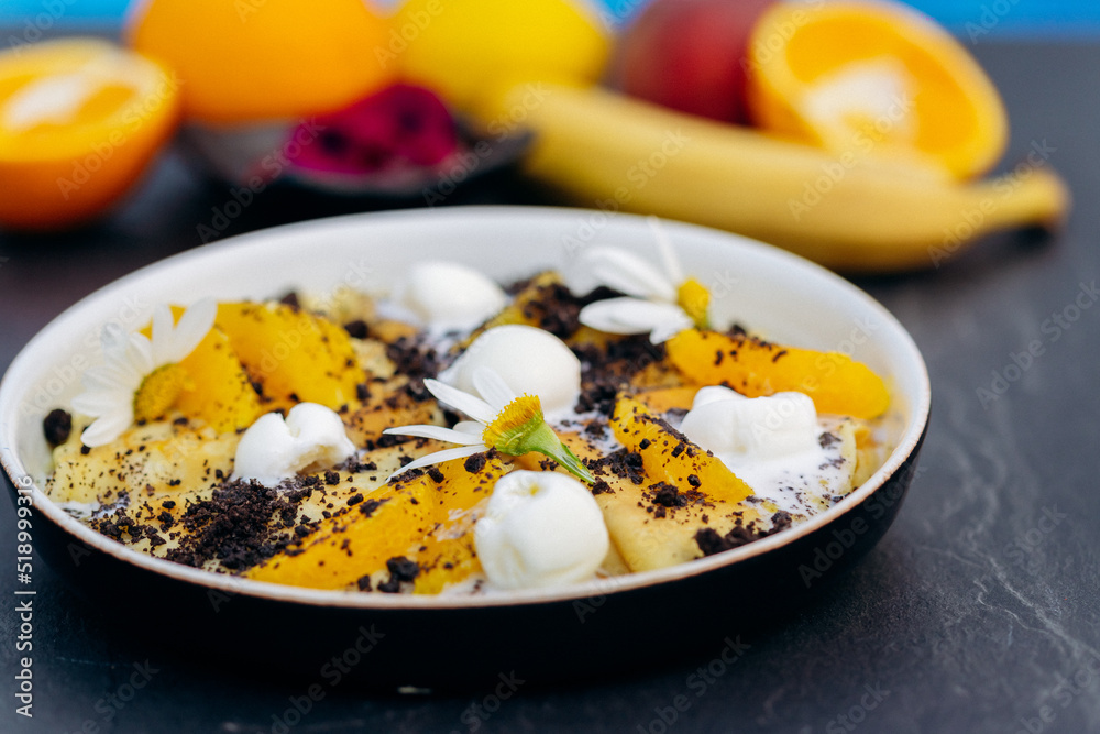 Sweet pancakes with ice cream, chocolate and orange served on white plate. Healthy and tasty breakfast Sweet pancakes with ice cream, chocolate and orange served on white plate. Healthy and tasty breakfast