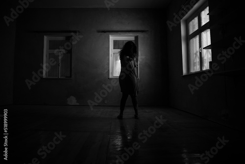 Horror woman in window wood hand hold cage scary scene halloween concept Blurred silhouette of witch. Horror theme