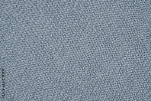 Light blue woven surface close-up. Linen textile texture. Fabric handicraft background. Pale textured braided backdrop. Len wallpaper. Macro