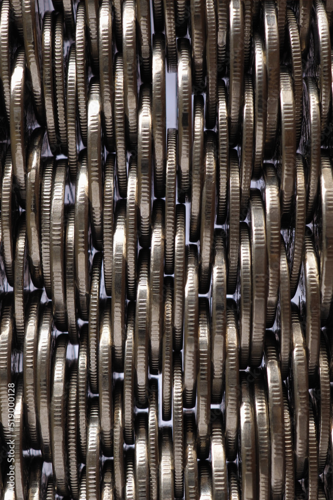 Money wall. Chaotic pile of coins close up. Nickel coin texture. Vertical business background made of many coin edges. Economy finance and bank backdrop. Tax and credit. Macro Money wall. Chaotic pile of coins close up. Nickel coin texture. Vertical business background made of many coin edges. Economy finance and bank backdrop. Tax and credit. Macro