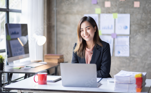 Business Accountant Young Asian female working on a laptop, doing calculator planning analyzing the financial report, business plan investment, finance analysis concept 