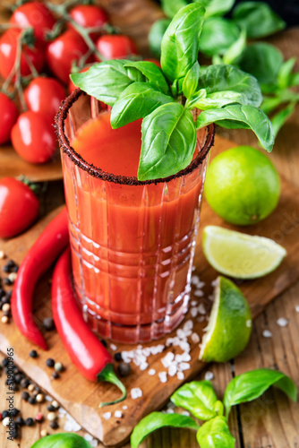 Drink Bloody Mary with peppers, lime and tomatoes