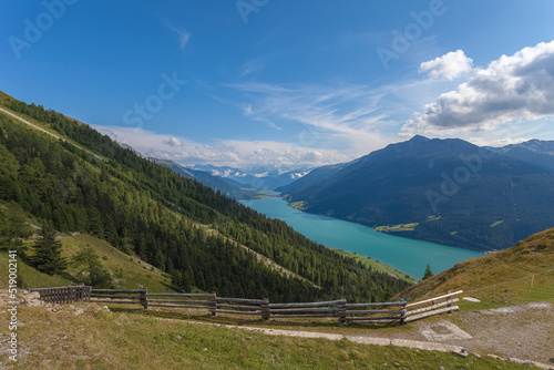 Awesome summer aerial panorama of Resia Lake with Ortles massif in the background. Resia Pass, Alto Adige Sudtirol, Italy