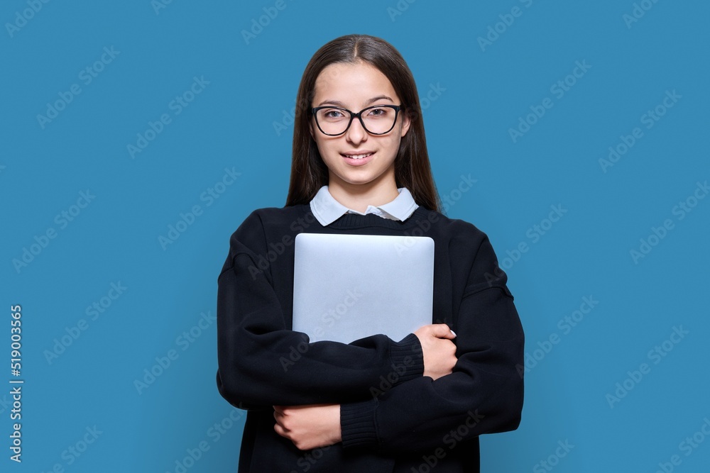 Teenage female student with laptop on blue color background Teenage female student with laptop on blue color background