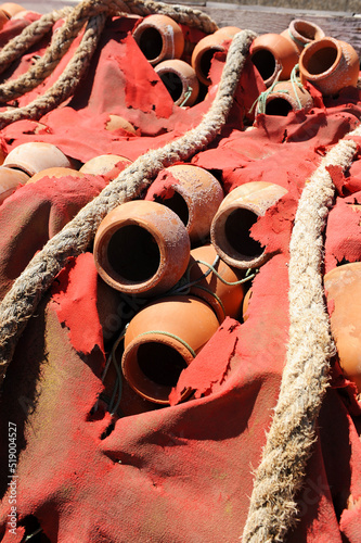 Octopus fishing. Ceramic pots named pulperas for octopus fishing stacked in the fishing port of Rota, Cadiz coast, Spain photo