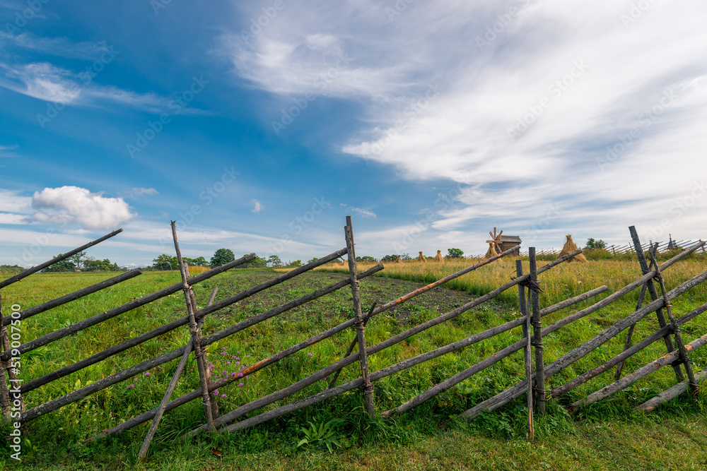 Wooden fence of the farm, made in the peoples of the Russian tradition of the north