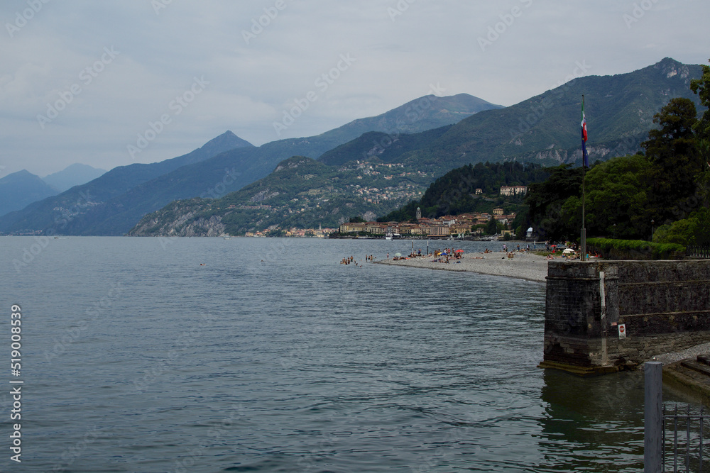 summer landscape of lake como with boat and tourists