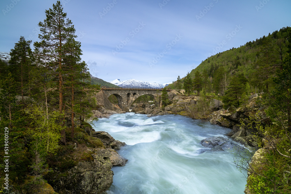 The Stuguflåt Bridge (Norwegian: Stuguflåtbrua or Stuguflåten bru), a stone railway bridge on the Rauma Line over the Rauma River in Innlandet county, Norway. The Stuguflåt Bridge (Norwegian: Stuguflåtbrua or Stuguflåten bru), a stone railway bridge on the Rauma Line over the Rauma River in Innlandet county, Norway.