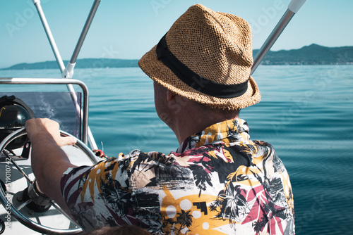 Driving motorboat on holiday. Man sailing an inflatable rubber motor boat on the sea. Boat rental close up