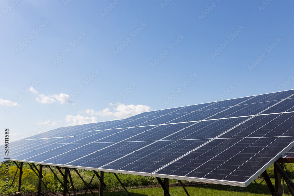 Solar panels on the background of a blue cloudy sky. Solar power plant. Blue solar panels. An alternative source of electricity. Solar farm in the field. Solar panels on the background of a blue cloudy sky. Solar power plant. Blue solar panels. An alternative source of electricity. Solar farm in the field.