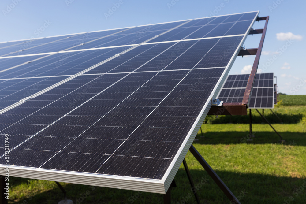 Powerful solar panels on blue cloudy sky background, concept of alternative clean green energy. Close up Powerful solar panels on blue cloudy sky background, concept of alternative clean green energy. Close up