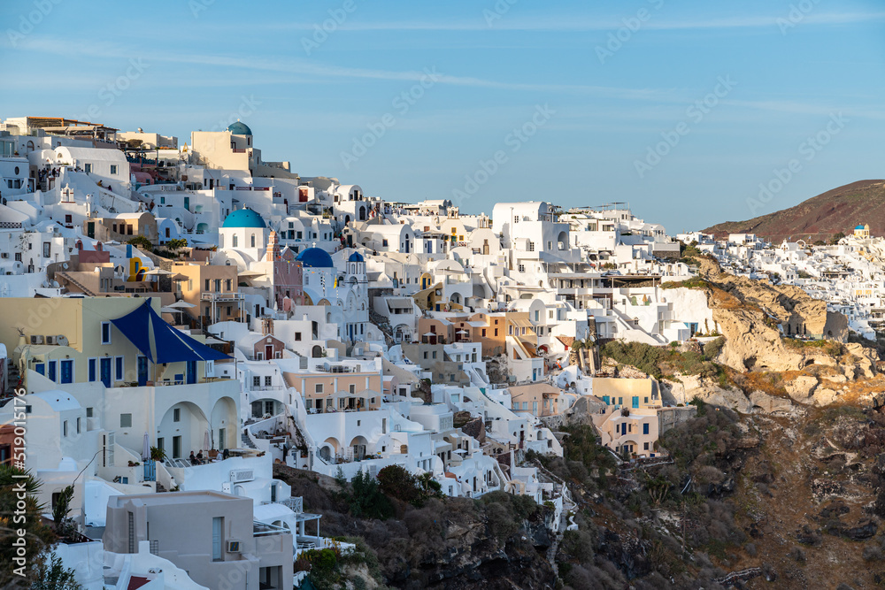 View of Oia with its famous whitewashed houses hosting luxury hotel suites, Santorini, Greece