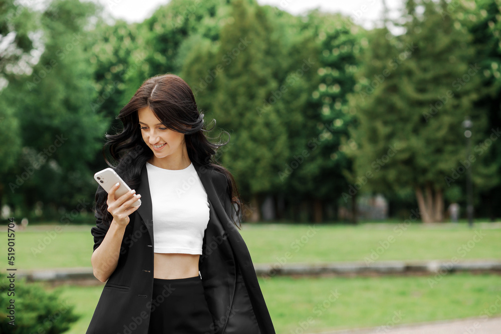 Professional woman talking on a mobile phone outdoors Professional woman talking on a mobile phone outdoors