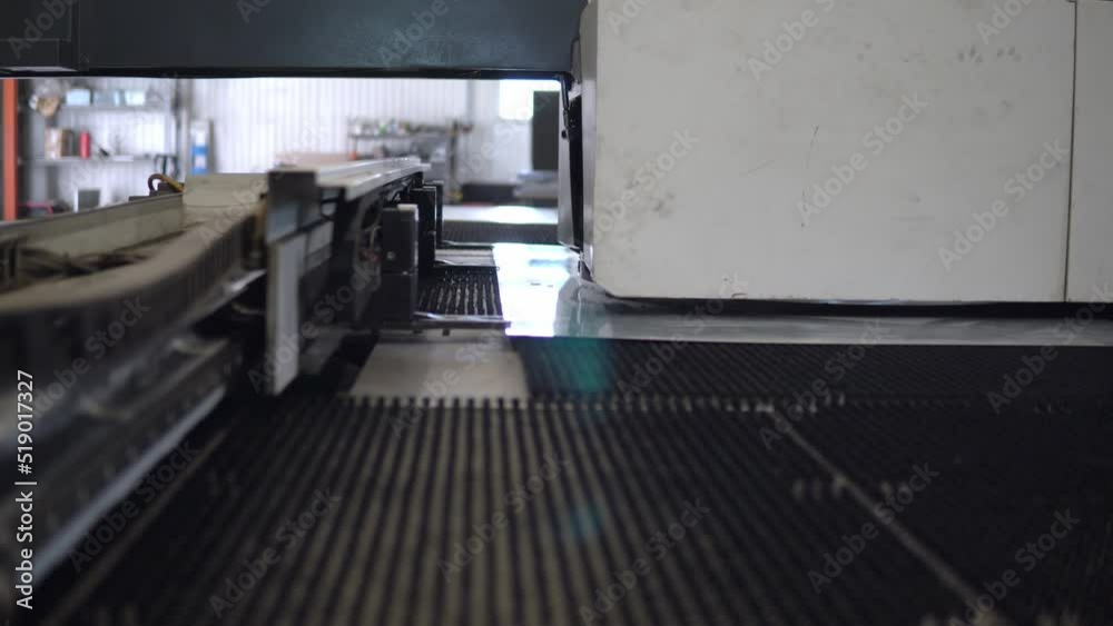 Metal punching machine at a modern industrial factory. Making the dealer on the CNC with a stamping machine Metal punching machine at a modern industrial factory. Making the dealer on the CNC with a stamping machine