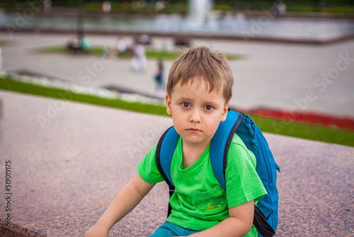 Portrait of a child, a boy against the backdrop of urban landscapes of skyscrapers and high-rise buildings in the open air. Children, Travel. Lifestyle in the city. Center, streets. © Alina Lebed