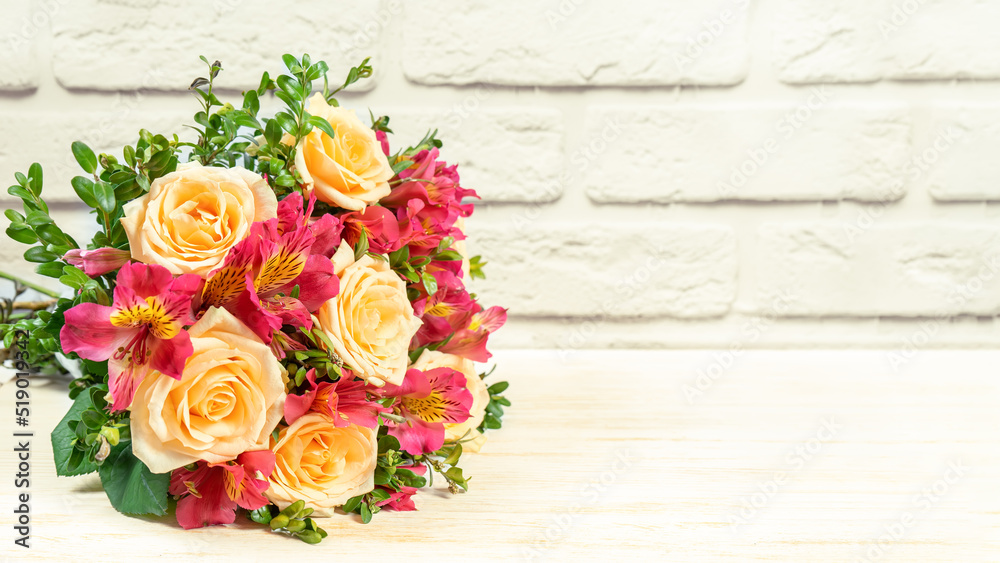 Bouquet of beautiful roses and alstroemeria on white brick background. Fresh, lush bouquet of colorful flowers for wedding, valenitnes day, mother day. Floral shop concept, mockup with copy space