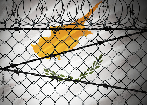 Cyprus flag behind barbed wire and metal fence