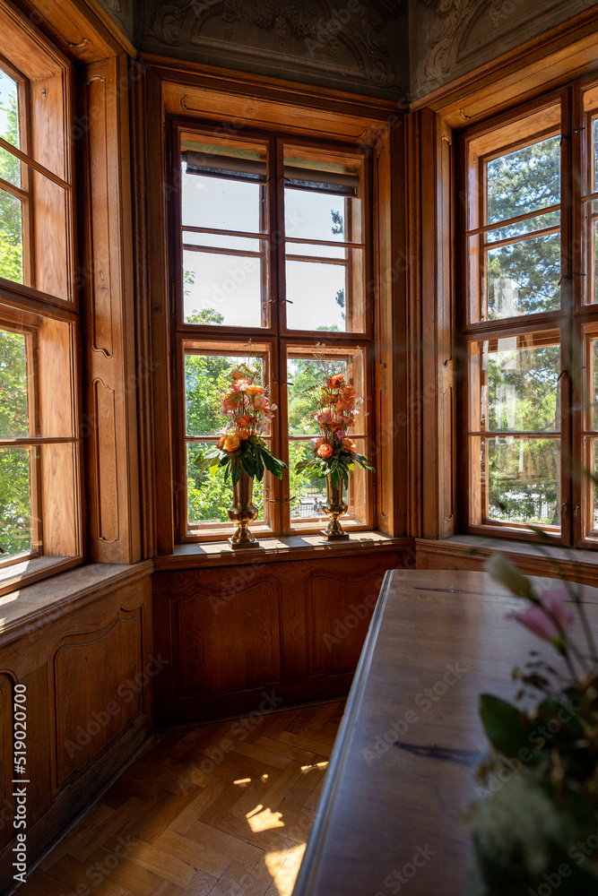 old building with big windows decorated with vases with flowers, daylight, bouquet of roses in wooden window, wedding decoration concept old building with big windows decorated with vases with flowers, daylight, bouquet of roses in wooden window, wedding decoration concept