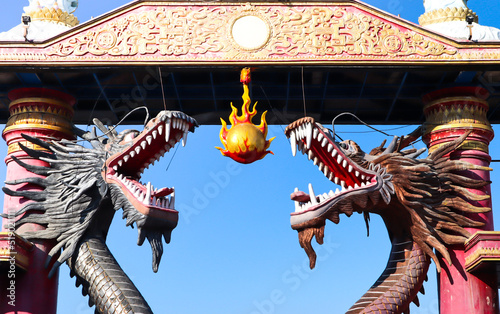 statue of 2 dragons 1 big fireball on the beach kenjeran surabaya photo