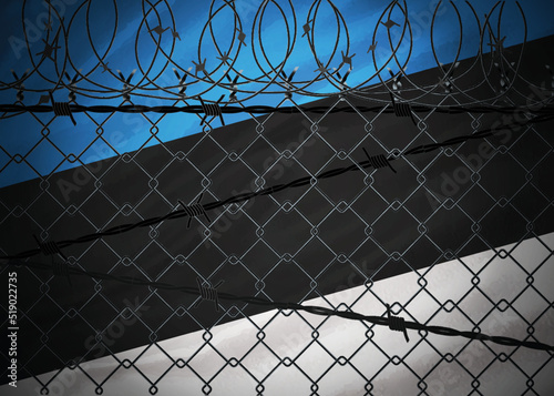 Estonia flag behind barbed wire and metal fence