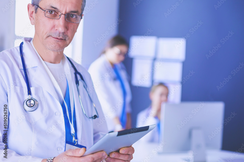 Portrait of a smiling doctor in his bright office
