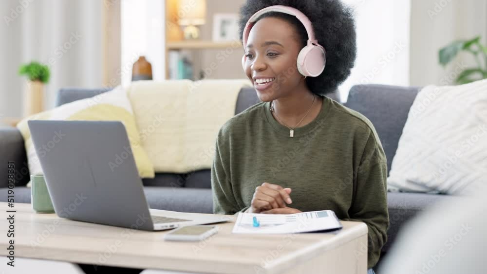 Online teacher talking on videocall using laptop and headphones while waving hello to students. Woman making note while communicating and learning new language during online course or private lesson