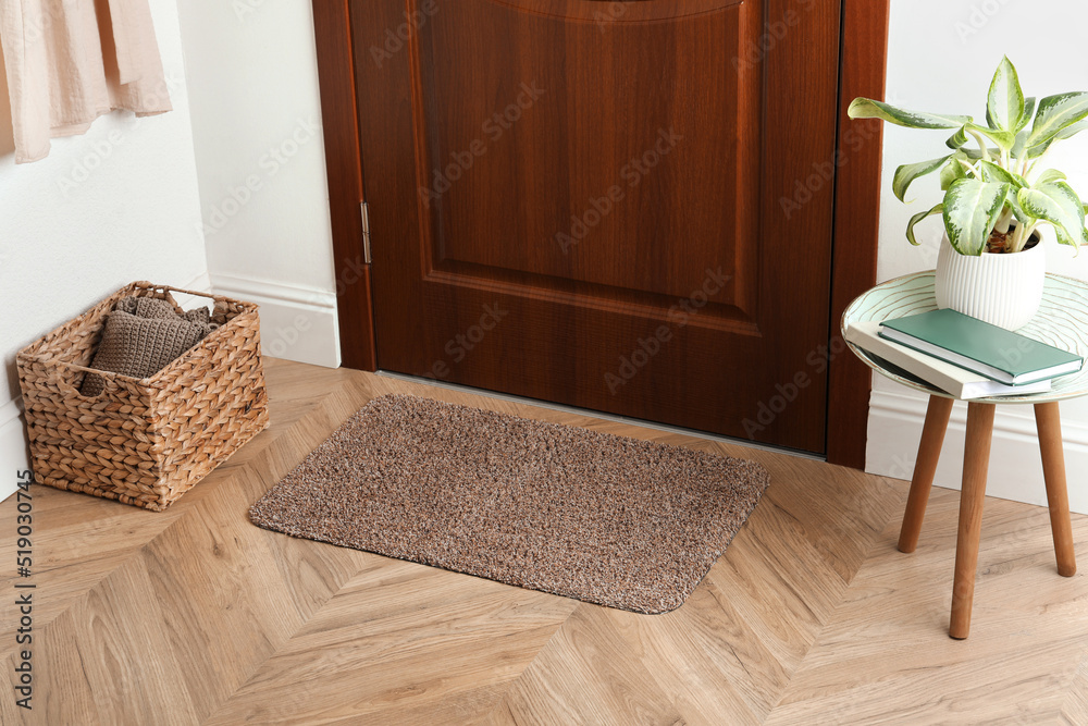 Clean door mat on wooden floor in hall - obrazy, fototapety, plakaty 