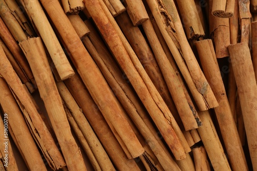 Aromatic cinnamon sticks as background, top view