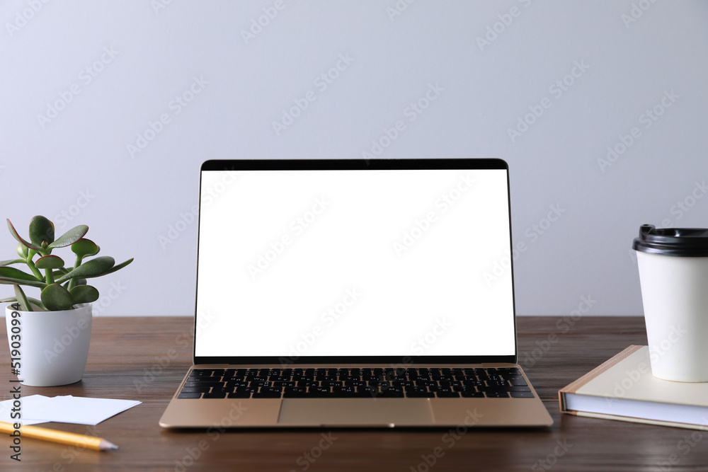 Workplace with modern laptop on wooden table. Mockup for design Workplace with modern laptop on wooden table. Mockup for design