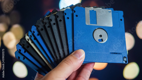 Lot of old floppy disks in men hand