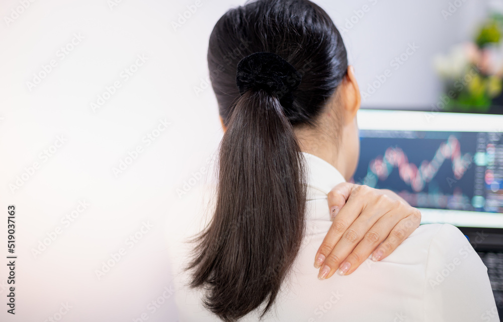 Fototapeta premium Asian young feeling painful from work, while sitting in front of the laptop in their home. Concept working woman office syndrome.