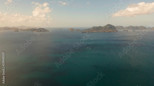 Seascape with tropical rocky islands, ocean blue water, aerial view . islands and mountains covered with tropical forest. El nido, Philippines, Palawan. Tropical Mountain Range