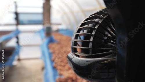 Fans in solar dryer greenhouse. A thermal control system for ventilation and temperature in coffee bean and cocoa seed drying process.
