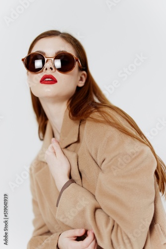 Catalog photography is a concept for designer clothes. Young girl in glasses and coat © SHOTPRIME STUDIO