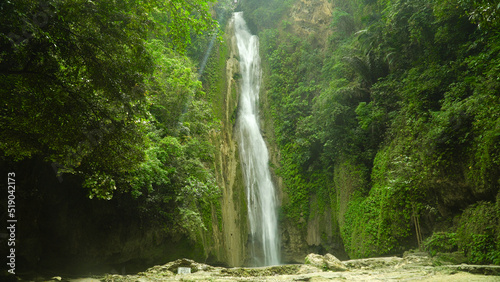 Waterfall in the rainforest jungle. Tropical Mantayupan Falls in mountain jungle. Philippines  Cebu.