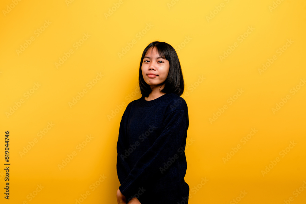 Cute Asian girl smiling on yellow background. Empty, young woman. Place for advertisement. copy space Cute Asian girl smiling on yellow background. Empty, young woman. Place for advertisement. copy space