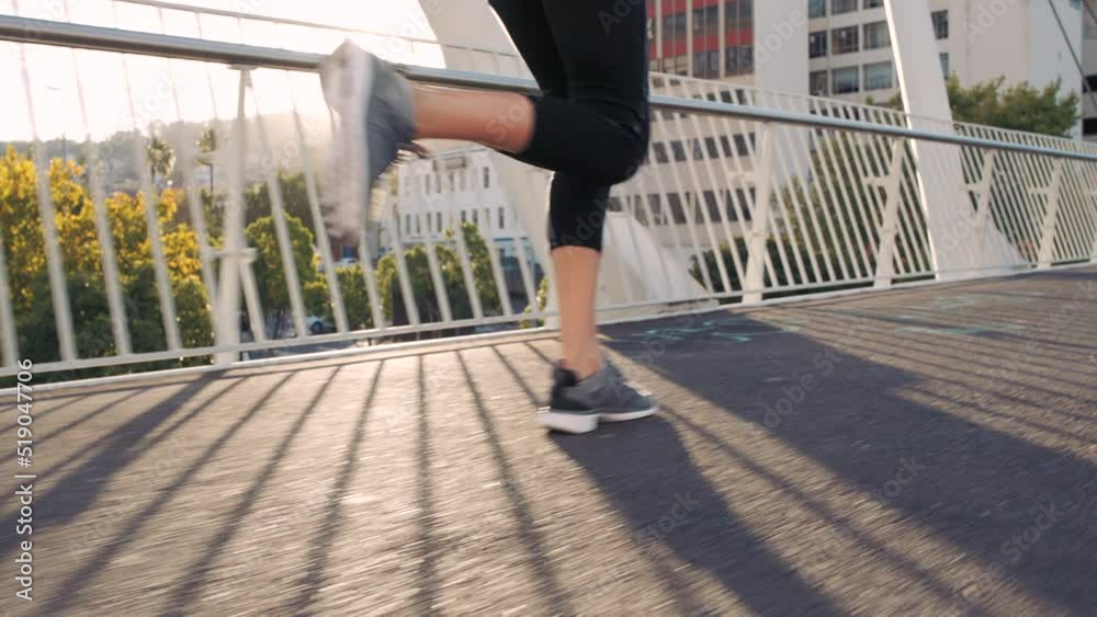 Fitness woman running and jogging on a bridge in the city outdoors. Closeup on legs of sporty athlete with running shoes doing endurance and stamina training. Exercising to stay fit and healthy Fitness woman running and jogging on a bridge in the city outdoors. Closeup on legs of sporty athlete with running shoes doing endurance and stamina training. Exercising to stay fit and healthy