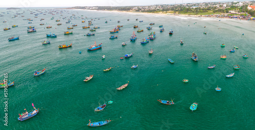 Mui Ne fishing village seen from above with hundreds of boats anchored to avoid storms, this is a beautiful bay in central Vietnam © huythoai
